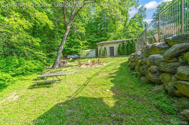 115 Audubon Dr, White Lake, MI 48383 - view of yard featuring a fire pit and an outbuilding