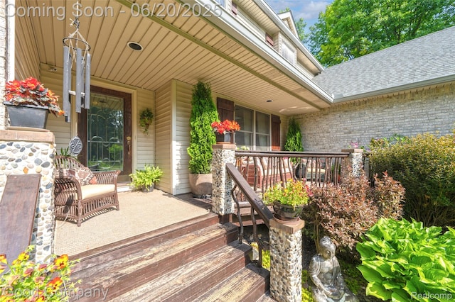 115 Audubon Dr, White Lake, MI 48383 - property entrance with a porch, roof with shingles, and brick siding