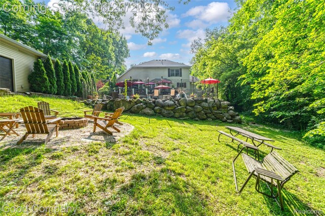 115 Audubon Dr, White Lake, MI 48383 - view of green lawn featuring a fire pit