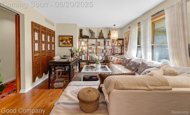 115 Audubon Dr, White Lake, MI 48383 - living area featuring wood finished floors and baseboards