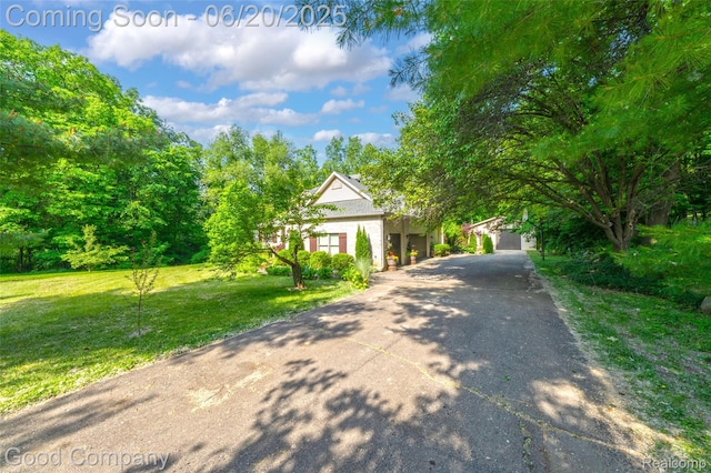 115 Audubon Dr, White Lake, MI 48383 - view of front of house featuring a front lawn and driveway