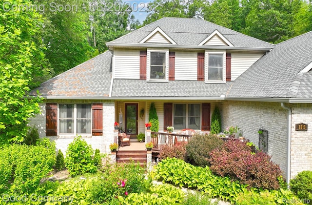 115 Audubon Dr, White Lake, MI 48383 - view of front of home featuring covered porch and roof with shingles
