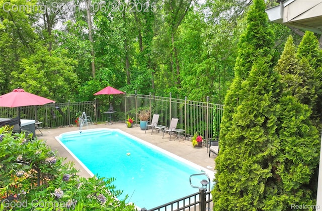 115 Audubon Dr, White Lake, MI 48383 - view of swimming pool featuring a patio
