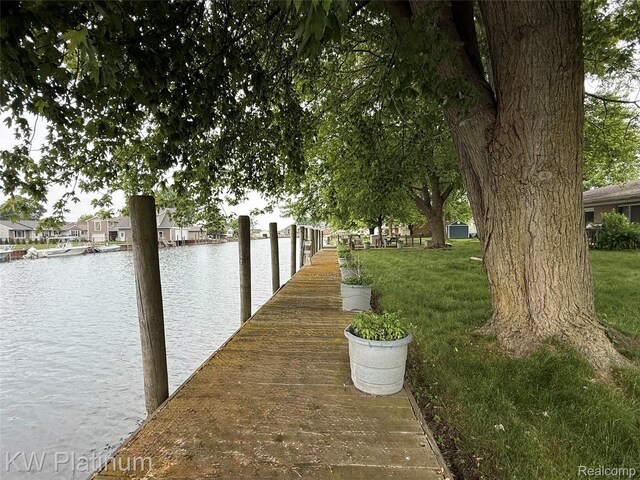 7275 Bluebill St, Clay, MI 48001 - view of home's community featuring a dock, a water view, and a lawn