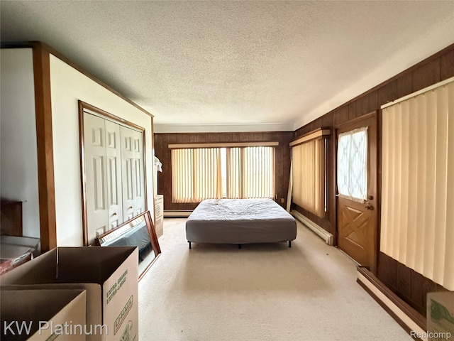 7275 Bluebill St, Clay, MI 48001 - bedroom with a textured ceiling, a baseboard heating unit, carpet, baseboard heating, and wooden walls