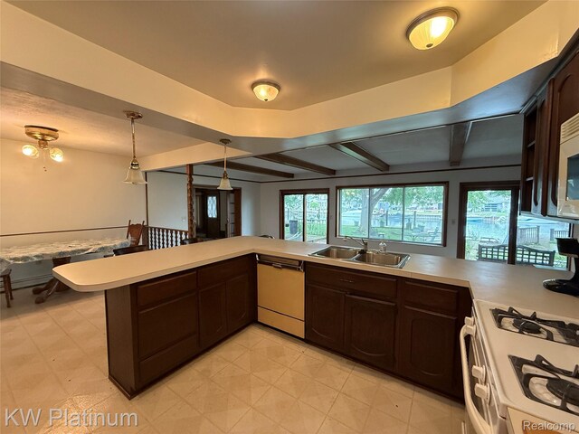 7275 Bluebill St, Clay, MI 48001 - kitchen featuring white appliances, light countertops, dark brown cabinetry, pendant lighting, and beam ceiling
