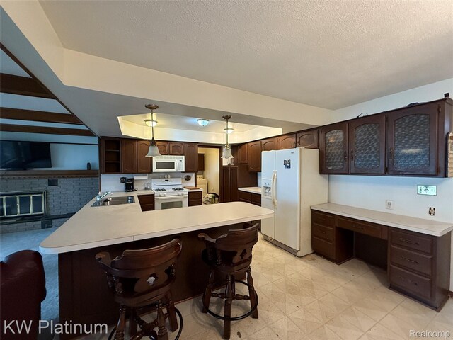 7275 Bluebill St, Clay, MI 48001 - kitchen with white appliances, dark brown cabinetry, a peninsula, light countertops, and a textured ceiling