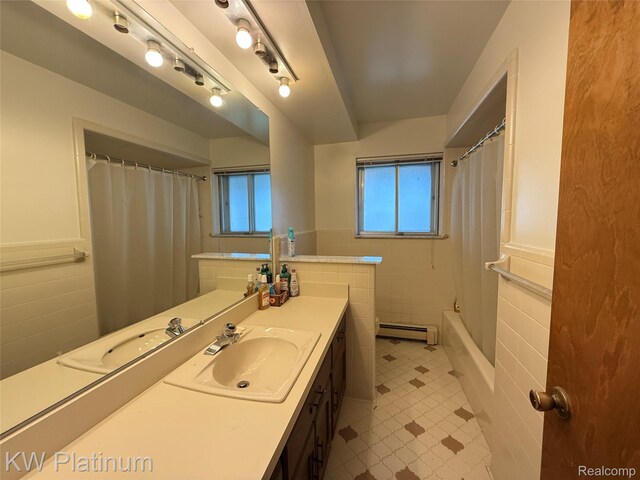 7275 Bluebill St, Clay, MI 48001 - full bathroom with a baseboard heating unit, vanity, tile walls, wainscoting, and shower / bath combo with shower curtain