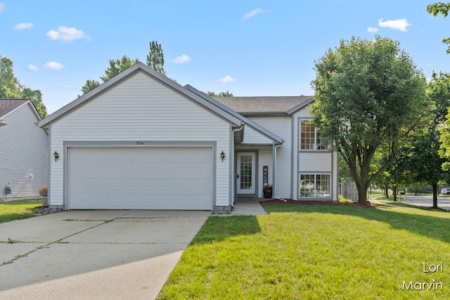 704 Pecan Ct NW, Grand Rapids, MI 49504 - view of front facade with a garage, driveway, and a front lawn