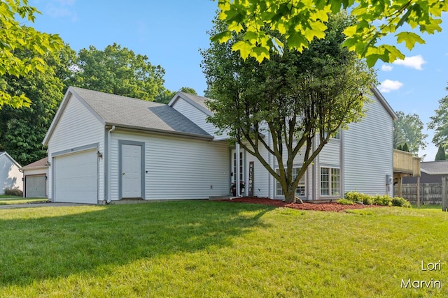704 Pecan Ct NW, Grand Rapids, MI 49504 - rear view of house featuring an attached garage and roof with shingles