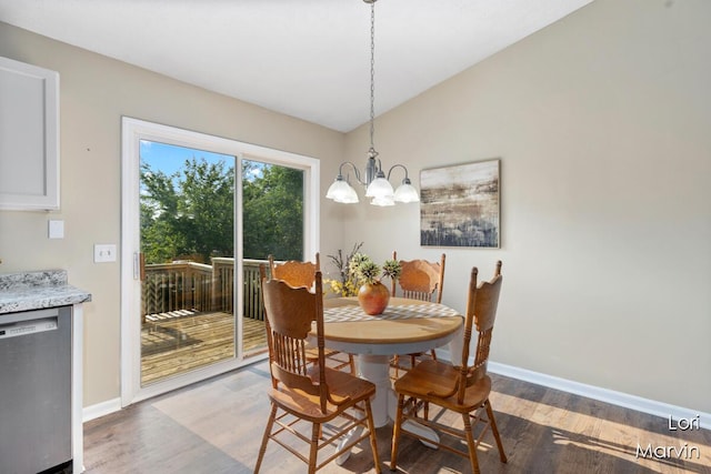 704 Pecan Ct NW, Grand Rapids, MI 49504 - dining room with wood finished floors and a chandelier