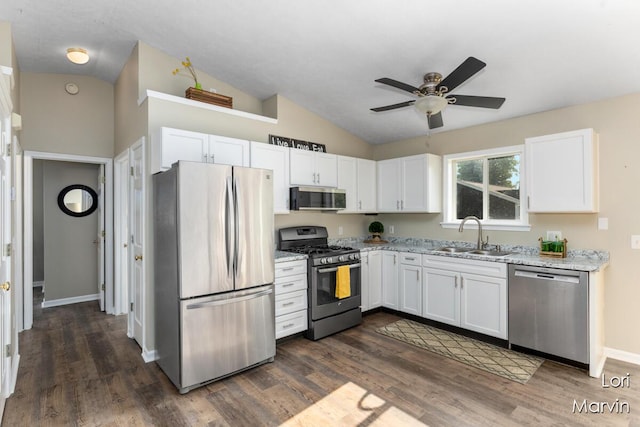 704 Pecan Ct NW, Grand Rapids, MI 49504 - kitchen with appliances with stainless steel finishes, white cabinetry, vaulted ceiling, a ceiling fan, and light stone counters
