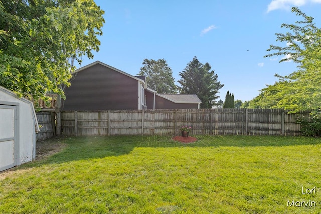 704 Pecan Ct NW, Grand Rapids, MI 49504 - fenced backyard featuring a storage shed