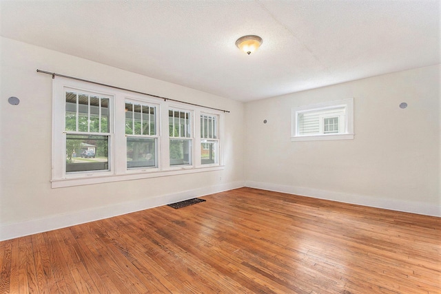 258 Richards Ave SW, Grand Rapids, MI 49504 - spare room featuring baseboards and hardwood / wood-style flooring