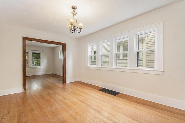 258 Richards Ave SW, Grand Rapids, MI 49504 - spare room with a chandelier and light wood-style floors