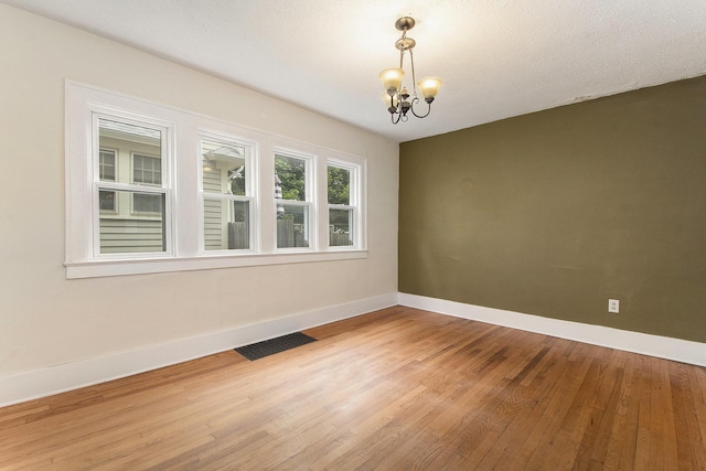 258 Richards Ave SW, Grand Rapids, MI 49504 - spare room featuring a chandelier and light wood-style floors