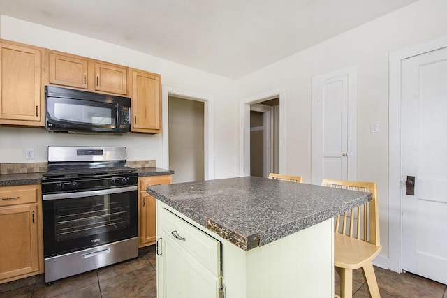 258 Richards Ave SW, Grand Rapids, MI 49504 - kitchen featuring stainless steel range with gas cooktop, black microwave, dark countertops, and a breakfast bar area