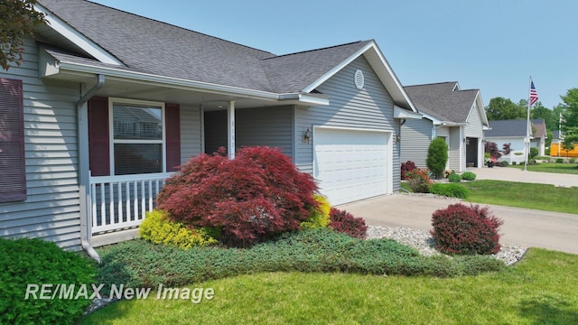 3137 Sundown Ln, Saginaw, MI 48603 - view of side of home with a shingled roof, driveway, a garage, and a porch