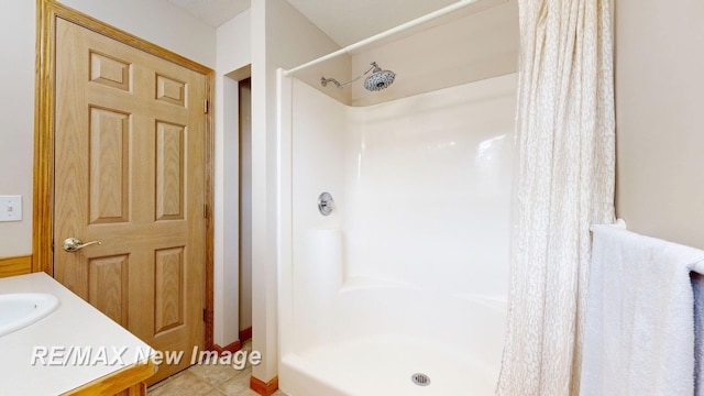 3137 Sundown Ln, Saginaw, MI 48603 - bathroom with curtained shower, tile patterned floors, and vanity