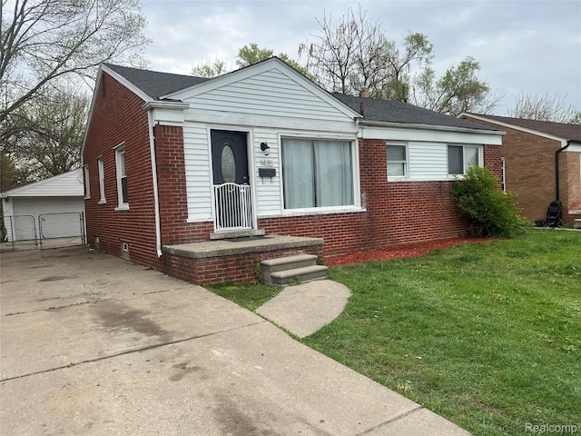 1435 Jeffrey Ln, Inkster, MI 48141 - bungalow-style home featuring brick siding, a front yard, an outbuilding, and roof with shingles
