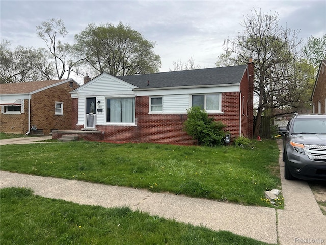 1435 Jeffrey Ln, Inkster, MI 48141 - view of front facade with brick siding, a front yard, and a chimney