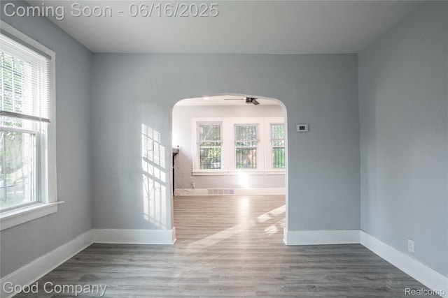 5217 Lakeview St, Detroit, MI 48213 - empty room with healthy amount of natural light, arched walkways, and wood finished floors