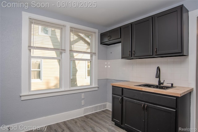 5217 Lakeview St, Detroit, MI 48213 - kitchen with butcher block countertops, backsplash, and wood finished floors
