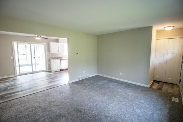 9461 Morrish Rd, Montrose, MI 48457 - unfurnished living room with ceiling fan, dark carpet, and dark wood finished floors
