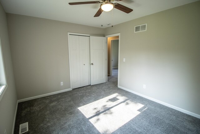 9461 Morrish Rd, Montrose, MI 48457 - unfurnished bedroom featuring carpet, a closet, and a ceiling fan