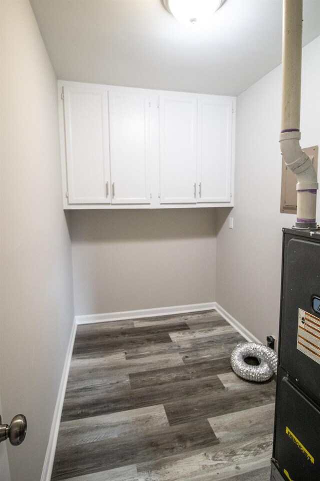 9461 Morrish Rd, Montrose, MI 48457 - laundry area with baseboards and dark wood-type flooring