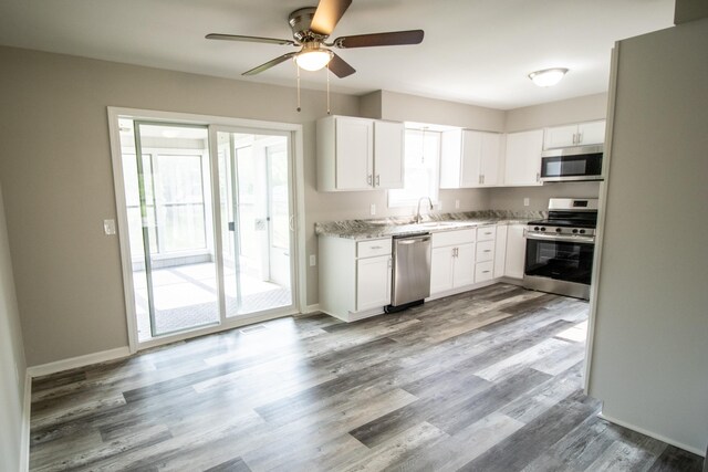 9461 Morrish Rd, Montrose, MI 48457 - kitchen featuring appliances with stainless steel finishes, a ceiling fan, wood finished floors, and white cabinets