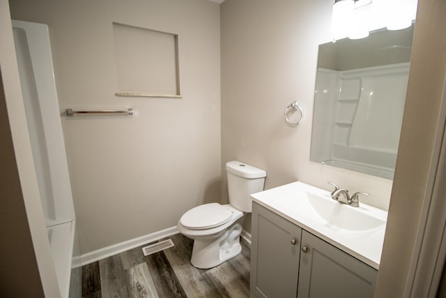 9461 Morrish Rd, Montrose, MI 48457 - full bathroom featuring wood finished floors, vanity, and a shower
