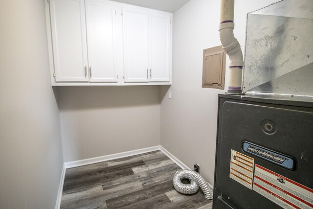 9461 Morrish Rd, Montrose, MI 48457 - laundry room featuring heating unit, cabinet space, and dark wood-style floors