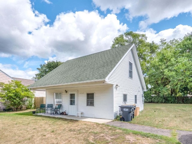 5747 Utah Ave, Portage, MI 49024 - rear view of property featuring a shingled roof and a patio area