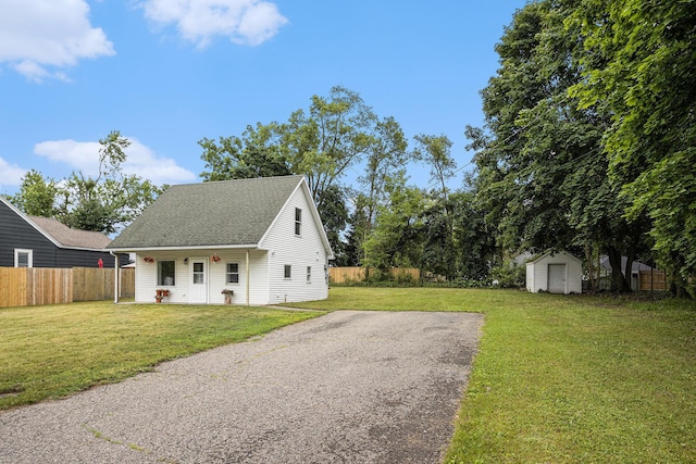 5747 Utah Ave, Portage, MI 49024 - view of front of house featuring a shed, a shingled roof, and driveway