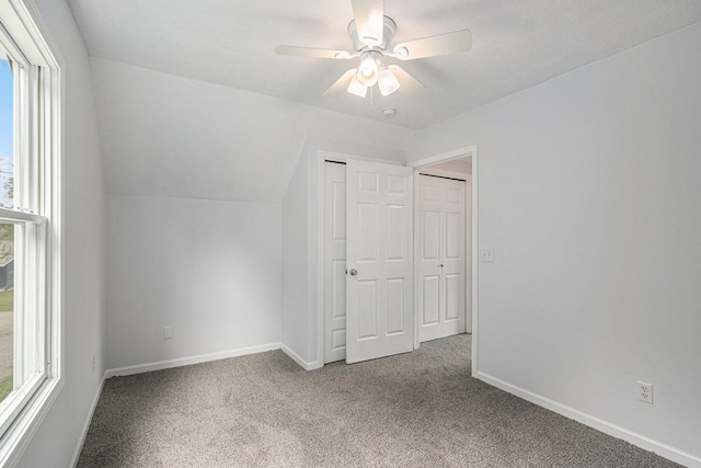 5747 Utah Ave, Portage, MI 49024 - unfurnished bedroom featuring multiple windows, carpet, lofted ceiling, and a closet