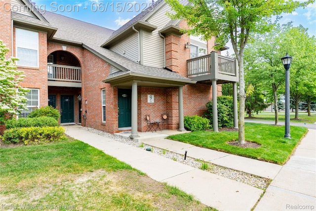 28498 Carlton Way Dr, Novi, MI 48377 - multi unit property featuring a balcony, brick siding, a shingled roof, and a front yard