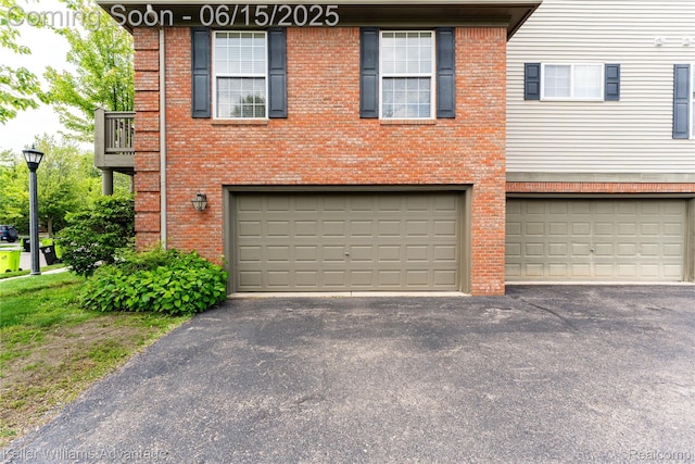 28498 Carlton Way Dr, Novi, MI 48377 - view of front of property featuring a garage, brick siding, and driveway