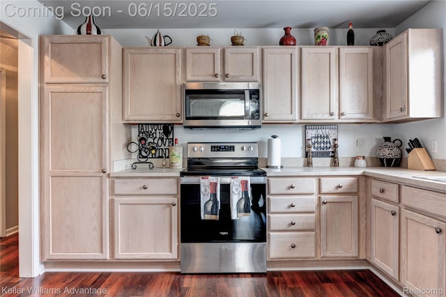 28498 Carlton Way Dr, Novi, MI 48377 - kitchen with stainless steel appliances, light brown cabinetry, light countertops, and dark wood-type flooring