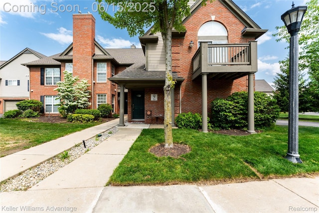 28498 Carlton Way Dr, Novi, MI 48377 - view of front facade featuring brick siding, a balcony, a front lawn, and a shingled roof