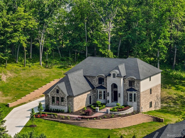 2584 Heights View Ct, Rochester, MI 48306 - french country style house with stone siding, driveway, and roof with shingles