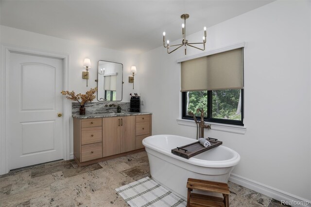 2584 Heights View Ct, Rochester, MI 48306 - full bathroom featuring vanity, a chandelier, a freestanding tub, and stone finish floors