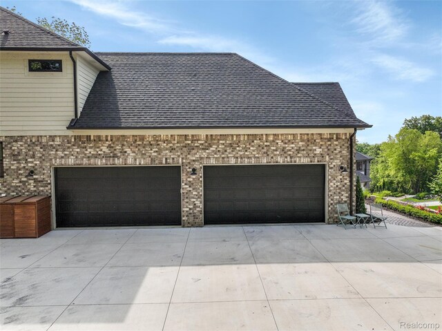 2584 Heights View Ct, Rochester, MI 48306 - view of side of home featuring concrete driveway, brick siding, an attached garage, and a shingled roof