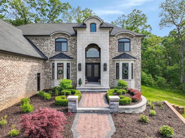 2584 Heights View Ct, Rochester, MI 48306 - french country inspired facade with french doors, roof with shingles, and brick siding