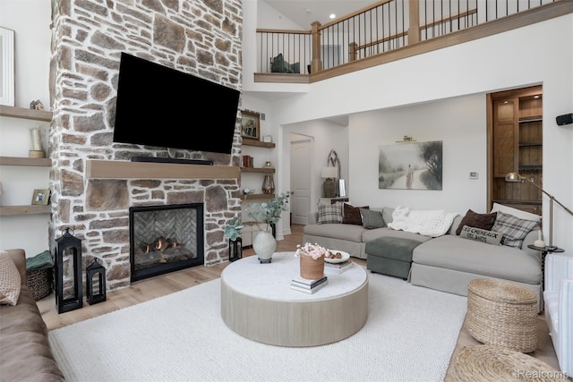 2584 Heights View Ct, Rochester, MI 48306 - living area featuring wood finished floors, a fireplace, and high vaulted ceiling