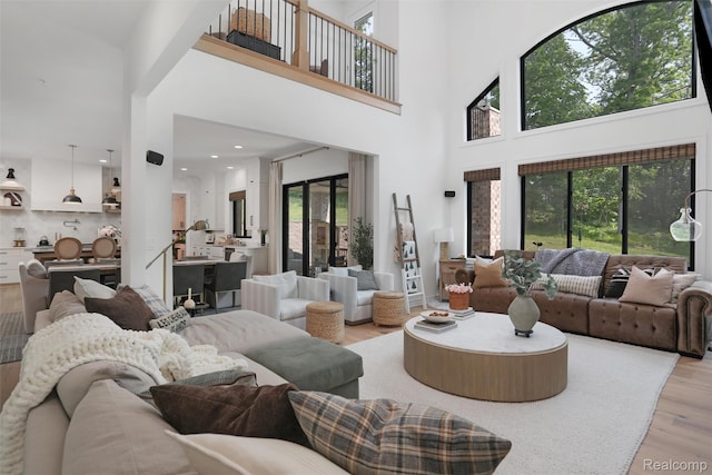 2584 Heights View Ct, Rochester, MI 48306 - living room with light wood-type flooring, a high ceiling, and plenty of natural light