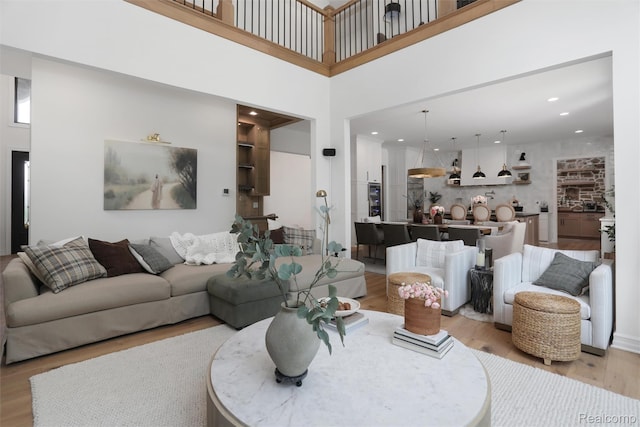 2584 Heights View Ct, Rochester, MI 48306 - living area with light wood-style flooring, recessed lighting, and a towering ceiling