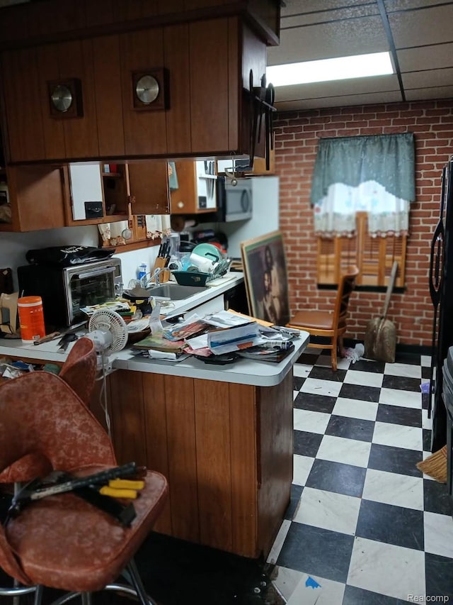 20527 Greeley St, Highland Park, MI 48203 - kitchen with dark floors, light countertops, and a peninsula