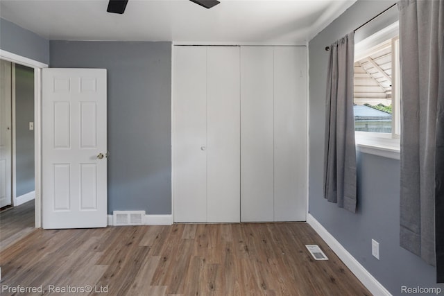 1330 Rahn St, Westland, MI 48186 - unfurnished bedroom with wood finished floors, a closet, and ceiling fan