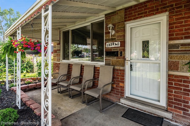 1330 Rahn St, Westland, MI 48186 - entrance to property with a porch and brick siding